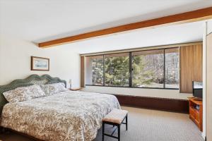 a bedroom with a bed and a large window at Notchbrook 13AB in Stowe Fork