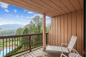 a porch with a chair and a view of a pool at Notchbrook 17ABC in Stowe