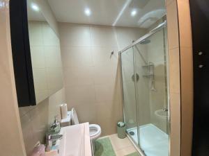 a bathroom with a shower and a toilet and a sink at Executive North London Southgate Serviced Apartment - Contractors Ready in East Barnet +14 photos