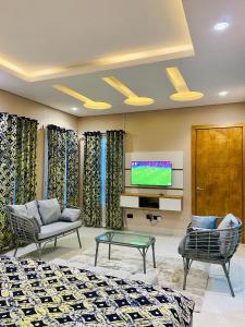 a hotel room with two beds and a tv at GRACE LODGE LEKKI Phase 1 in Araromi