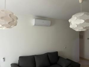 a living room with a couch and two lights at Casa Caletillas in Candelaria