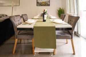 a dining room table with a green table cloth on it at Relaxing 5BDR Retreat Hot Tub in Allesley