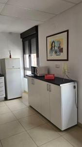 a kitchen with a refrigerator and a counter top at apartamento la carrera in Mondaria