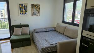 a living room with a couch and a chair at LIMONCELLO Apartment in Bar +21 photos