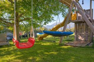 a playground with swings in a yard at Ferienwohnung Brandterhof in Brandenberg