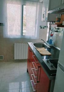 a kitchen with a sink and a counter top at Habitación pensión Tolima - baño compartido in Cabezón de la Sal