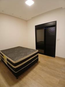 un matelas posé dans une pièce avec une porte dans l'établissement Casa de 3 quartos em Franca - Piscina aquecida, banheira, conforto e lazer, à Franca