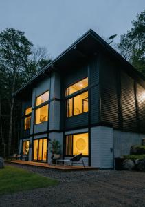 a house with large windows on the side of it at Zen House 5 - Villas & Spa in Lac-Superieur