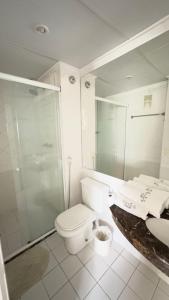a bathroom with a toilet and a shower and a sink at TrevizZo Mercure! in Sao Paulo