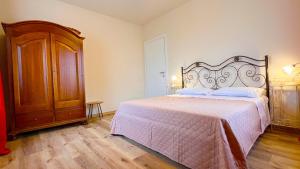 a bedroom with a bed and a wooden cabinet at Casa Salcheto in Montepulciano