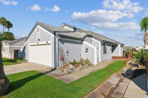 a white house with a garage at Waterfront Escape with Private Dock home in Discovery Bay