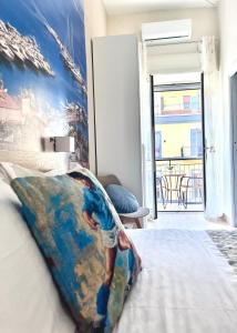 a bedroom with a bed with a painting on the wall at Arenaccia House Naples Center Welcome Wine in Naples