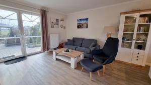 a living room with a couch and a table at Garten-Landhaus Relax in Walchum