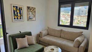 a living room with a couch and a table at LIMONCELLO Apartment in Bar
