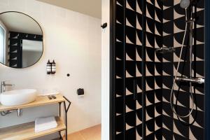 a bathroom with a sink and a mirror at Hotel Zeedijk City Centre in Amsterdam