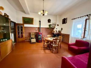 a living room with a table and a red couch at I colori dell'orizzonte in Santo Stefano