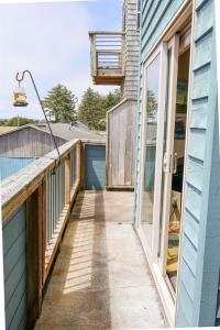 a balcony with a view of a house at Stunning Oceanview Townhouse Walk to Seawall, Shops & Depoe Bay Dining in Depoe Bay