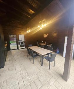 a dining room with a table and some chairs at IUNIk in Azuga +15 photos