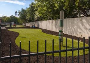 a fence in front of a park with a fence at South Congress Austin Modern 2BR with Pool, Hot Tub, Convenient to Nightlife in Austin