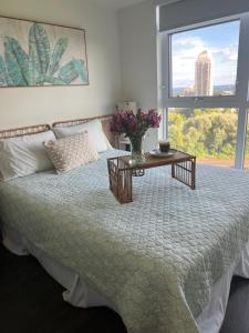 a bedroom with a bed with a table and a window at Lakeview Steps to the lake & just minutes to downtown in Toronto