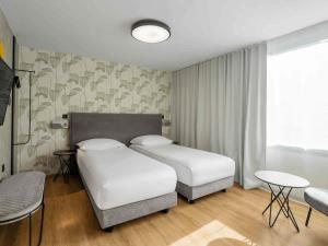 Postel nebo postele na pokoji v ubytování ibis Styles Ljubljana Centre