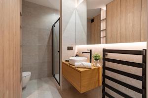 a bathroom with a sink and a toilet at Luxury Apartment Mennica Residence strefa wellness and sport by P&M in Warsaw +15 photos