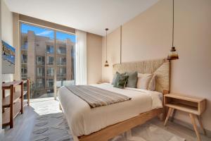 a bedroom with a bed and a large window at Bohari Las Arenas in Cabo San Lucas +156 photos