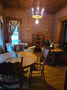 a dining room with tables and chairs and a chandelier at The Parker House Bed and Breakfast in Bath +25 photos