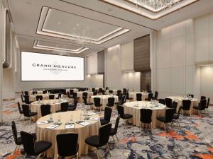 a conference room with tables and chairs and a screen at Grand Mercure Bangkok Atrium in Bangkok +145 photos