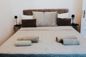 a bedroom with a large bed with two pillows at Jacuzzi-2 sauna-wine cellar-Rechnerschieber in Đakovo