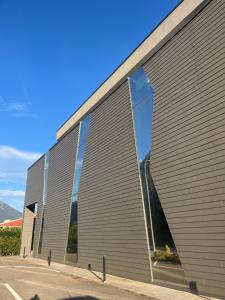 a large metal building with a large window at Affittacamere Zafferano in Belluno