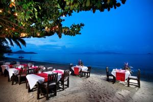 a restaurant with tables and chairs on the beach at Smile House - Fisherman Village in Bophut