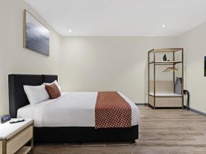 a hotel room with a bed and a dresser at BreakFree on Broadway Sydney, an Accor Hotel in Sydney +46 photos