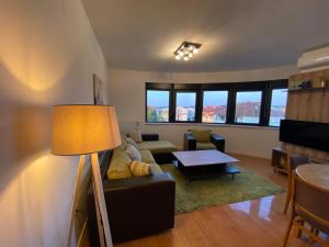 a living room with a couch and a table at Panoramic View Apartment in Kragujevac