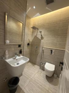 a bathroom with a white sink and a toilet at Riyadh Luxury Narjis in Riyadh +15 photos