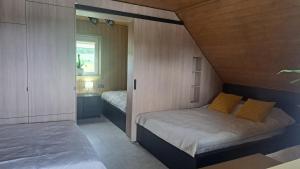 a small bedroom with a bed and a window at Ūdros slėnis in Bildžiai