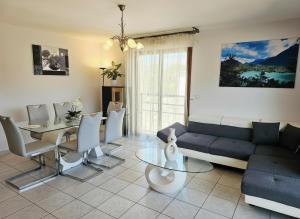 a living room with a couch and a table at Au cœur de St Jorioz, spacieux appartement avec terrasse et vue montagne. in Saint-Jorioz