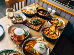 a table with plates of food and glasses of wine at ibis Coleraine Riverside in Coleraine