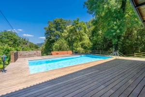 a swimming pool on top of a wooden deck at Moinhos do Coto in Vila Verde