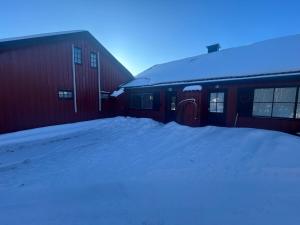 a snow covered building with a snow pile next to it at Nice apartment at Golsfjellet in Gol