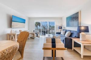 a living room with a couch and a table at South Seas Resort - Official Site in Captiva