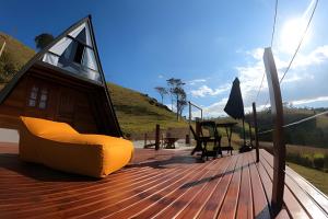 a deck with a chair and a table on a boat at Chalesunset in Santa Isabel
