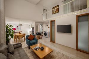 a living room with a couch and a table at Amber Bay Hotel & Suites Da Nang in Da Nang