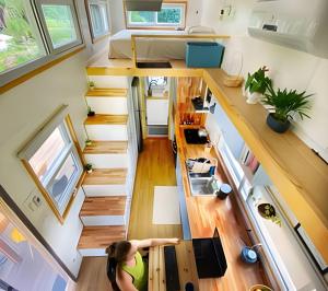 an aerial view of a tiny house with a staircase at Experiência única na Toca Turquesa – Natureza e conforto in Santa Isabel