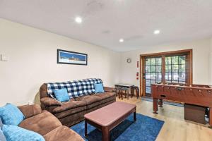 a living room with a couch and a pool table at Pocono's Resort - Fire Pit Jacuzzi Winter Sports Amenities in Lake Ariel +71 photos