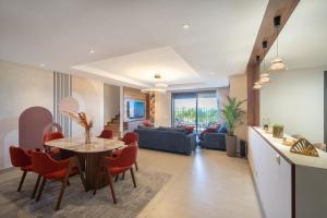 a kitchen and living room with a table and chairs at Marina Premium Residences in Casablanca