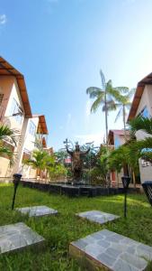 a statue in the middle of a park with palm trees at Machu Picchu Selva Hotel in Isla Chinería +25 photos