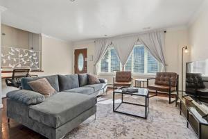 a living room with a couch and a tv at Group Chic - 25 Mins to NYC - FREE Parking - Washer & Dryer in Fairview