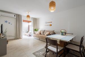 a living room with a couch and a table at Apto c/ Churrasqueira a 230 m da Praia SHA0104 in Piçarras