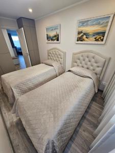 two beds in a bedroom with two beds at E.D. Luxury Apartaments in Šiauliai
